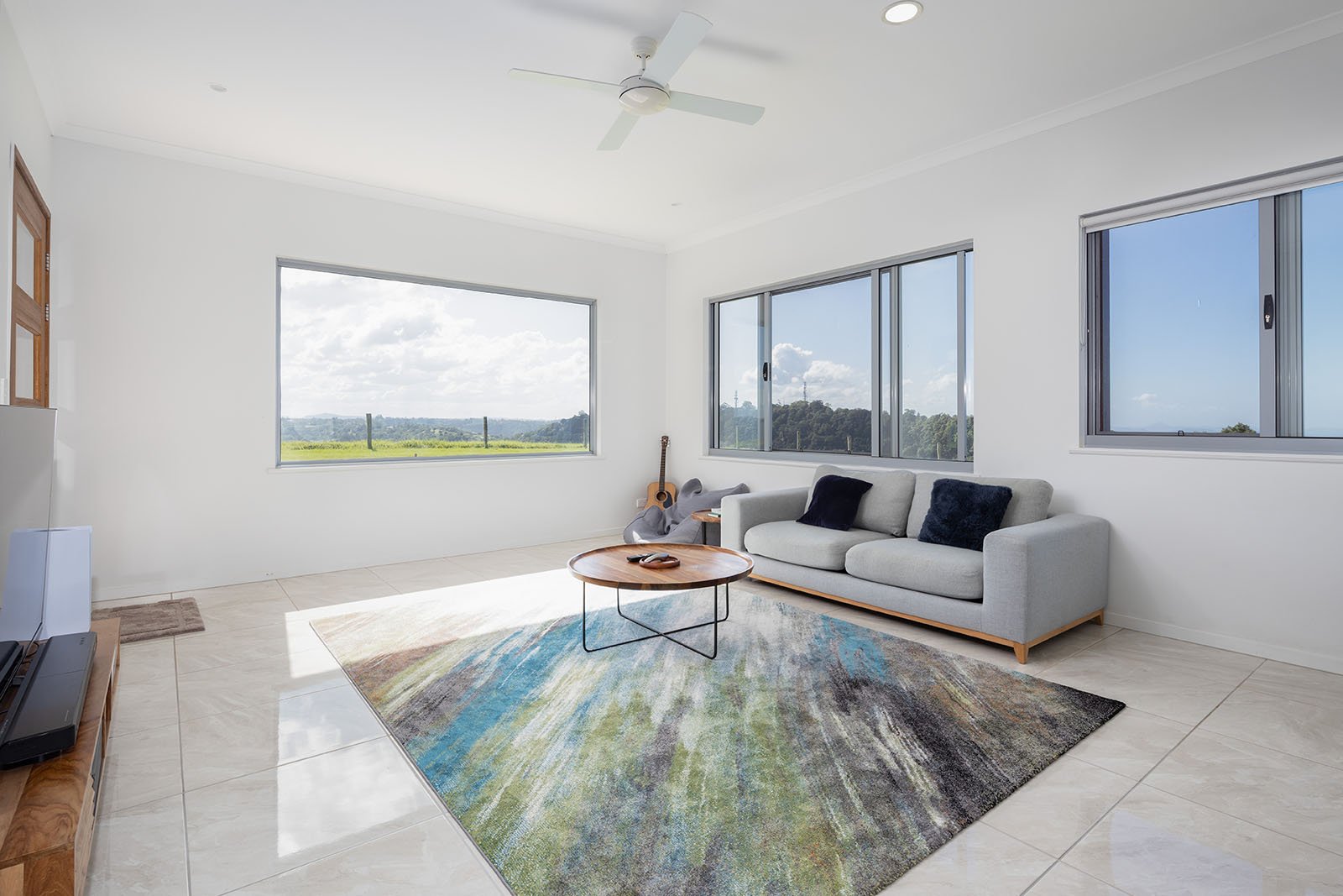 Petrichor Estate's modern living room with stunning mountain views. Ideal for a relaxing Sunshine Coast getaway